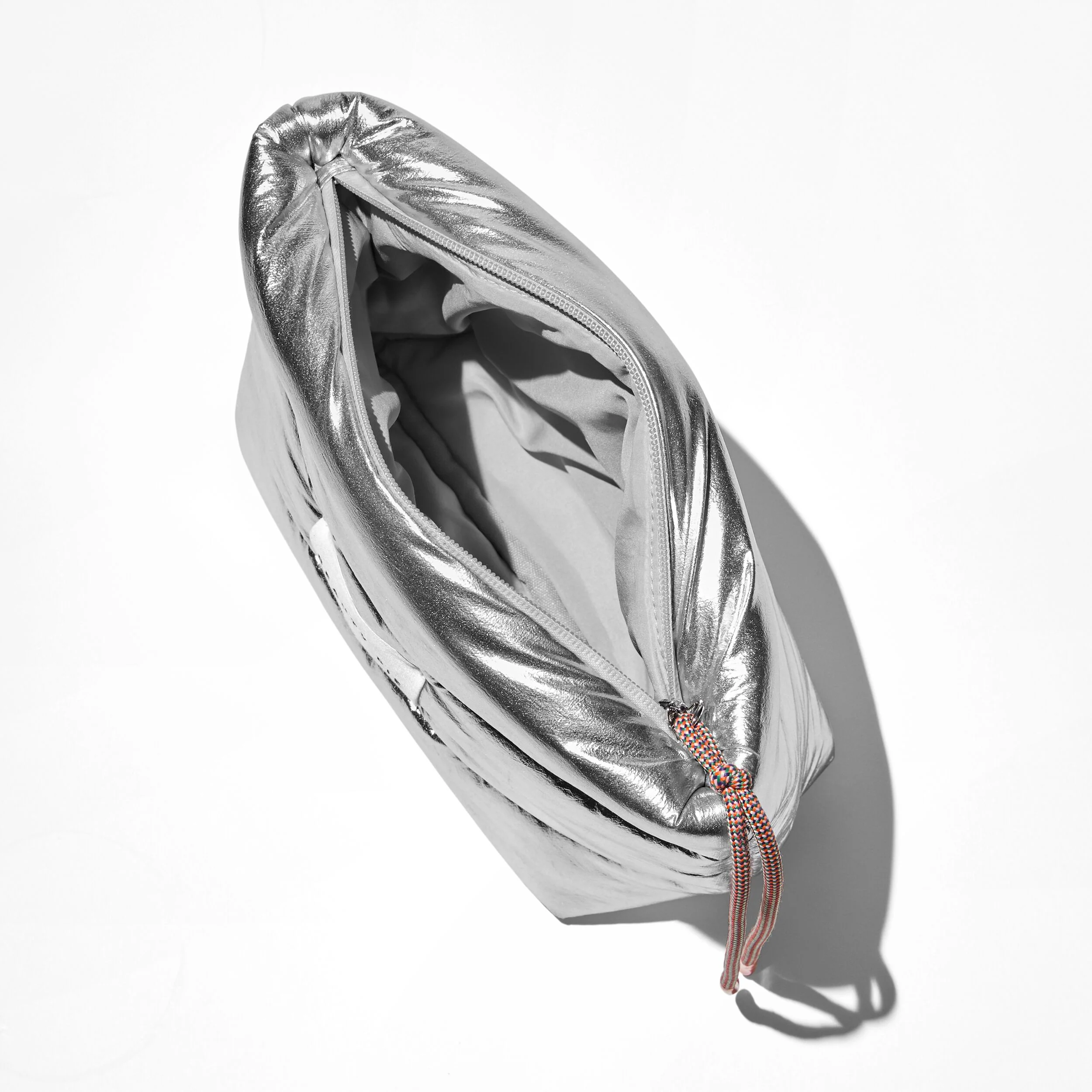 The Perfectly Puffy Silver Beauty Bag in Vegan Materials with Orange Zip-Pull